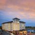 Hotel Indigo Jacksonville-Deerwood Park By IHG exterior at sunset beside a lake in Jacksonville
