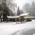 Dunsmuir Lodge in Dunsmuir covered in snow with trees and a lodge building