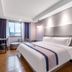 Xiamen Junming Hotel guest room with king bed, window seat, desk and wall-mounted TV in Xiamen