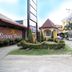 Sunny Point Hotel in Davao City entrance with landscaped driveway, brick sign, and yellow building
