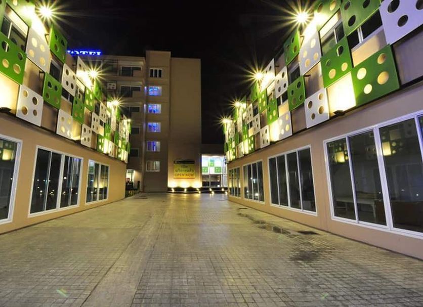 Tanzeno Hotel in Nong Khai, exterior courtyard with colorful illuminated facades at night