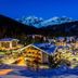 Hotel Pinzolo-Dolomiti in Pinzolo at night, overlooking a snowy alpine village and mountains