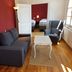 Haus Stehlings in Monschau: living area with sofa, armchair, coffee table and bedroom visible
