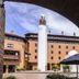Travelers Condominio Plenitud in Bogotá courtyard with tall white tower and brick archway
