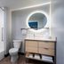 TownePlace Suites by Marriott Brunswick bathroom with shower-tub combo, vanity, round mirror and toilet
