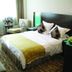 Nan Xiang Hotel Guiyang guest room with bed, chair, side tables and window light