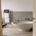 Norfolk Mead, Norwich bathroom with freestanding tub, towel rack and light wood flooring