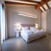 Villa Nicolli Romantic Spa Resort - Adults Only room in Riva del Garda with twin bed, wooden beams and seating area