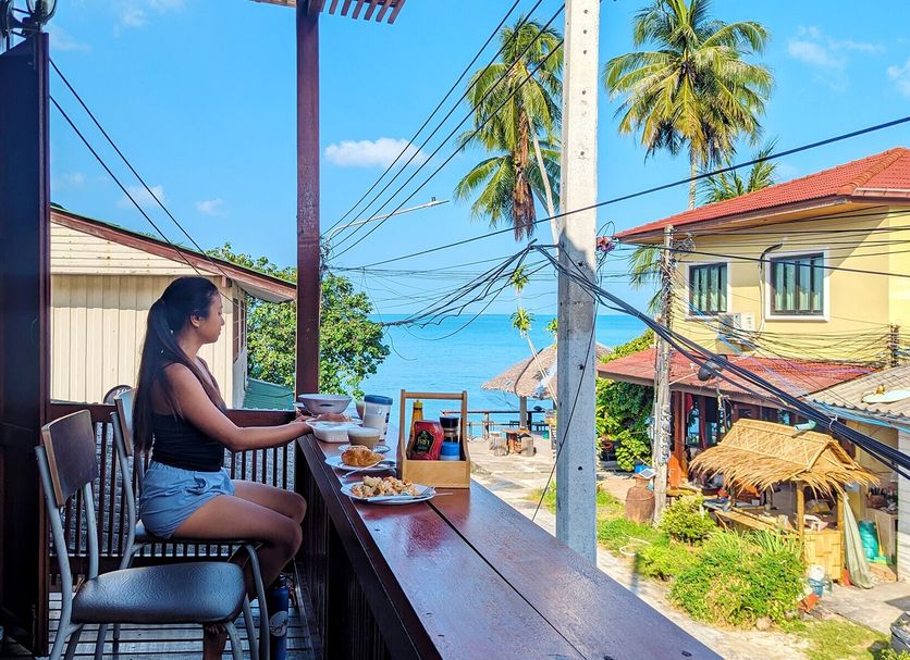 Aforetime Beach House in Ko Samui terrace dining with ocean view and palm trees