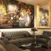Villablanca Garden Beach Hotel in Cozumel lobby with jungle mural, gray sofas and glass coffee table