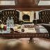 Hotel-Restaurant Barbarossahof in Kaiserslautern: elegant lounge with leather chairs, marble table, and fruit tray