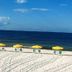 Casa Loma, Panama City Beach beach view with yellow umbrellas and lounge chairs by the ocean
