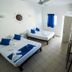 Hotel Paraiso Kora in San Blas: simple guest room with two beds, blue accents, wall TV and desk
