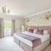 Bartley Lodge Hotel Southampton guest room with king bed, floral wallpaper, desk and window