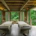 An Lam Retreats Ninh Van Bay spa room with two massage beds and forest views in Thon Dam Van