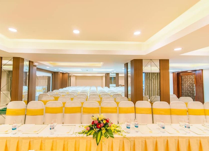 Asia Paradise Hotel in Nha Trang banquet hall with rows of chairs and a decorated front table