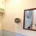 Garden Guest House Hong Kong bathroom with shower, water heater and wall mirror