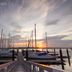 Jb City Hotel in Johor Bahru marina with sailboats at sunset and calm water