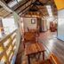 Bamboo Bungalow Resthouse Boracay hallway with wooden benches, tables, and thatched roof interior