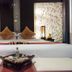 Palette Bangkok Natural Resort and Spa in Bangkok, bed with spa tray and patterned pillows in a room