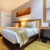 Grand Serela Yogyakarta twin guest room with wood headboard, desk and wall-mounted TV