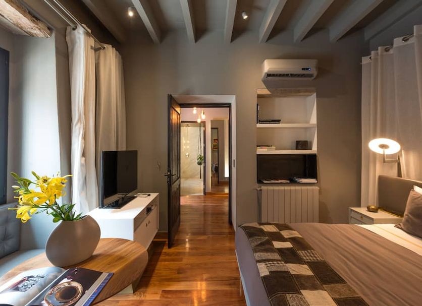 Dos Casas Hotel & Spa room in San Miguel de Allende with bed, wood beams, TV and window seating