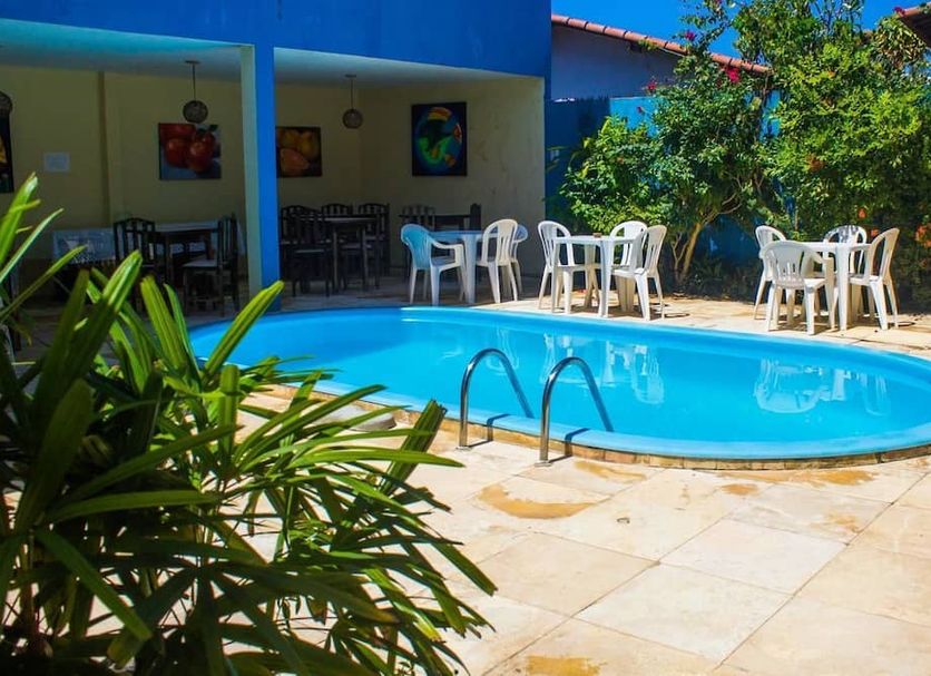 Pousada Pé na Areia in Pipa with an outdoor swimming pool and patio seating