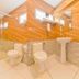 Hotel F Square in Kochi bathroom with two toilets, glass shower, and pedestal sink