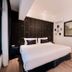 Sabai Mansion Pool & Spa in Krabi, compact bedroom with queen bed, wood floor and wall mirror