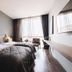 Spice House Chiang Mai guest room with twin beds, window seating and city view