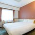 Toyoko Inn Hanshin Amagasaki Ekimae guest room with double bed and window seating in Amagasaki