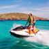 Hotel Marfil Sant Antoni de Portmany jet ski on turquoise sea near rocky island
