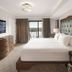 Disney's Riviera Resort bedroom in Lake Buena Vista with balcony view and tufted headboard