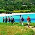 Feriendorf Zum Stoerrischen Esel in Calvi, hillside path to a turquoise bay with beachgoers