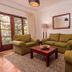 Bronte Hotel Harare living room with sofas, coffee table, rug and French doors to balcony