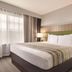 Country Inn & Suites by Radisson, Merrillville, IN guest room with king bed and large window