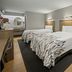 Red Roof Inn Greensboro Airport in Greensboro guest room with two double beds and wall-mounted lights