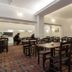 The Glendeveor in Newquay dining room with wooden tables and chairs and patterned carpet