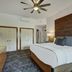 The Osprey at Beaver Creek guest room with king bed, large headboard, ceiling fan and dresser