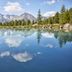 Hotel Alpenkönigin - Alpine Luxury in See, mountain lake with pine trees and reflected peaks