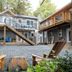 The Francis Boutique Inn in Ucluelet, courtyard with gravel seating area, tree stump table and exterior stairs