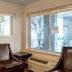 HomeTowne Studios by Red Roof Salem, OR guest room with two leather chairs and large windows