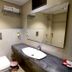 The Grand Radiant Hotel Lucknow bathroom with sink, toilet, mirror and wall shelf