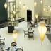 Concorde Paris Tunis lounge with hanging pendant lights, seating areas, and black tables