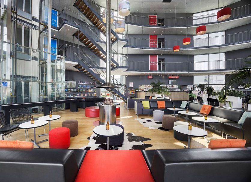 Aiden by Best Western Skavsta Airport in Nyköping lobby lounge with modern seating and open atrium