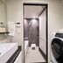Koko Hotel Osaka Namba Sennichimae bathroom with sink, shower, and stacked washer-dryer in Osaka