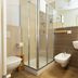 La Loggia de' Banchi bathroom with glass shower, wall-mounted sink, and bidet in La Spezia