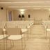 Th Costa Rei - Free Beach Resort meeting room in Costa Rei with rows of white chairs facing a presentation table