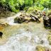 Las Brisas Resort and Villas in Jacó: people swimming and standing on rocks in a jungle stream
