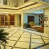 OYO Hexi Hotel in Zhangye lobby with revolving door, seating area and tiled floor